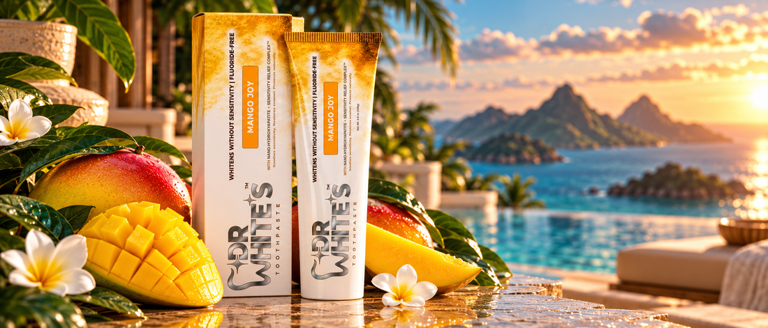 Dr. White’s Mango Joy toothpaste box and tube with mangoes beside a golden-hour tropical pool.